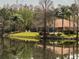 Lakeside pool with ample deck space surrounded by mature trees and greenery at 4952 Matteo Trl, Orlando, FL 32839