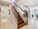 Staircase with wood treads and white risers, leading to the upper level and flowing into the rest of the home at 4952 Matteo Trl, Orlando, FL 32839