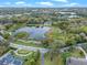 Stunning aerial view of a home nestled near a serene lake surrounded by lush greenery at 500 Forest Lake Dr, Altamonte Springs, FL 32714