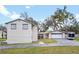 View of back of house with a detached garage and wide driveway, perfect for extra parking at 500 Forest Lake Dr, Altamonte Springs, FL 32714