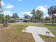 Large backyard with mature trees, fire pit, and a charming fountain feature at 500 Forest Lake Dr, Altamonte Springs, FL 32714