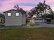 Night view of back of house with a detached garage and wide driveway, perfect for extra parking at 500 Forest Lake Dr, Altamonte Springs, FL 32714