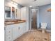 Bright bathroom with a double vanity sink, walk-in shower with glass door, and patterned tile at 500 Forest Lake Dr, Altamonte Springs, FL 32714