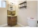 Bathroom with modern wood vanity, copper sink, mosaic backsplash, decorative mirror, and toilet at 500 Forest Lake Dr, Altamonte Springs, FL 32714