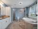 Modern bathroom with a large tub, walk-in shower, and granite countertops at 500 Forest Lake Dr, Altamonte Springs, FL 32714