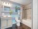 Charming bathroom with horizontally striped accent wall, tile shower and floors at 500 Forest Lake Dr, Altamonte Springs, FL 32714