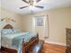 Bedroom with hardwood floors, window with curtains, ceiling fan and comfortable-sized bed at 500 Forest Lake Dr, Altamonte Springs, FL 32714