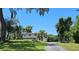 Two-story home with a large yard and mature trees providing ample shade on a sunny day at 500 Forest Lake Dr, Altamonte Springs, FL 32714