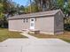 Exterior view of the accessory dwelling unit (ADU) with gray siding at 500 Forest Lake Dr, Altamonte Springs, FL 32714