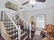 Inviting foyer features staircase with white spindles and dark iron balusters, and leads into a cozy living area at 500 Forest Lake Dr, Altamonte Springs, FL 32714