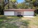 Detached garage with multiple bays for parking and storage on grassy lot at 500 Forest Lake Dr, Altamonte Springs, FL 32714