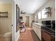 Cozy kitchen with breakfast bar seating, leading into the living room at 500 Forest Lake Dr, Altamonte Springs, FL 32714