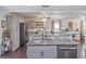 Open concept kitchen with gray cabinetry, stainless steel appliances, granite countertops and hardwood floors at 500 Forest Lake Dr, Altamonte Springs, FL 32714
