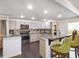 Renovated kitchen featuring granite countertops, stainless steel appliances, and bar seating at 500 Forest Lake Dr, Altamonte Springs, FL 32714