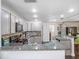 Updated kitchen showcasing granite countertops, stainless appliances, gray cabinets, and dark wood-look flooring at 500 Forest Lake Dr, Altamonte Springs, FL 32714