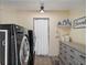 Laundry room features side-by-side washer and dryer with shelving and decor at 500 Forest Lake Dr, Altamonte Springs, FL 32714