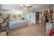 Serene main bedroom with a floral bedding, ceiling fan, walk in closet, and ample space for relaxation at 500 Forest Lake Dr, Altamonte Springs, FL 32714
