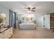 Spacious main bedroom features light blue walls, carpeted floors, a ceiling fan, and a decorative accent wall at 500 Forest Lake Dr, Altamonte Springs, FL 32714