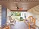 Cozy covered patio featuring comfortable seating, ceiling fan, and serene views of the backyard at 500 Forest Lake Dr, Altamonte Springs, FL 32714