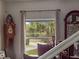 Picturesque window view framing a pond and tropical palm trees, enhancing the home's connection to nature at 500 Forest Lake Dr, Altamonte Springs, FL 32714