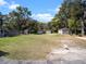 Large, grassy yard includes several outbuildings, a white chicken, and mature trees at 500 Forest Lake Dr, Altamonte Springs, FL 32714