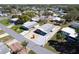 An aerial view of a single-story home with mature landscaping and a driveway in a well-maintained community at 519 Tivoli Park Dr, Davenport, FL 33897