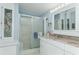 Well-lit bathroom featuring a glass door shower, vanity, and ample storage space at 519 Tivoli Park Dr, Davenport, FL 33897