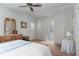 Comfortable bedroom with wallpaper, a ceiling fan, and an ensuite bathroom at 519 Tivoli Park Dr, Davenport, FL 33897