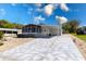 Single-story home featuring a large driveway with custom geometric detail at 519 Tivoli Park Dr, Davenport, FL 33897