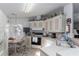 Eat-in kitchen with white cabinetry, modern appliances, and breakfast table at 519 Tivoli Park Dr, Davenport, FL 33897
