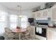 Eat-in kitchen featuring white appliances, a breakfast table, and bright natural light at 519 Tivoli Park Dr, Davenport, FL 33897