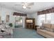 Comfortable living room featuring a ceiling fan, carpeting, and access to an enclosed lanai at 519 Tivoli Park Dr, Davenport, FL 33897