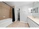 Bathroom featuring tiled shower and tub alongside a double vanity, a blend of comfort and convenience at 5412 Caramella Dr, Orlando, FL 32829