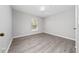 Empty bedroom with hardwood floors and window allowing ample sunlight at 5412 Caramella Dr, Orlando, FL 32829