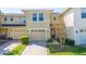 Inviting townhome with a well-manicured lawn and a single-car garage with a neutral colored door at 5412 Caramella Dr, Orlando, FL 32829