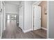 Bright hallway with hardwood floors and multiple doors at 5412 Caramella Dr, Orlando, FL 32829