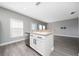 Modern kitchen island with stainless steel dishwasher and gray countertops at 5412 Caramella Dr, Orlando, FL 32829
