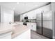 Bright kitchen with stainless steel appliances, white cabinets, and modern backsplash at 5412 Caramella Dr, Orlando, FL 32829
