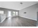 Spacious living area with gray wood floors, neutral walls, and bright natural light from several windows at 5412 Caramella Dr, Orlando, FL 32829