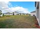 Large backyard with green grass and newly built homes in the community at 5719 Cattle Ranch Dr, St Cloud, FL 34771