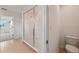 Modern bathroom featuring tile floors, large glass shower and water closet at 5719 Cattle Ranch Dr, St Cloud, FL 34771