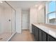 Modern bathroom featuring tile floors, large glass shower and dark gray cabinets at 5719 Cattle Ranch Dr, St Cloud, FL 34771