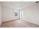 Bedroom featuring neutral carpet, white walls, and a window showing the building across the street at 5719 Cattle Ranch Dr, St Cloud, FL 34771