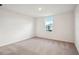 Bedroom featuring neutral carpet and white walls and a window with a view of the building outside at 5719 Cattle Ranch Dr, St Cloud, FL 34771