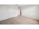 Bedroom with neutral carpet, baseboards, and white walls with two doors for closet and hallway at 5719 Cattle Ranch Dr, St Cloud, FL 34771