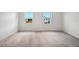 Neutral carpet, white walls and trim in this upstairs bedroom with lots of natural light at 5719 Cattle Ranch Dr, St Cloud, FL 34771