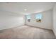 Upstairs bedroom featuring neutral carpet, white walls and trim and lots of natural light at 5719 Cattle Ranch Dr, St Cloud, FL 34771