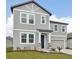 Attractive two-story home with a gray exterior, inviting entrance, and a well-maintained front lawn at 5719 Cattle Ranch Dr, St Cloud, FL 34771