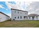Back exterior view of the house, featuring a covered patio at 5719 Cattle Ranch Dr, St Cloud, FL 34771