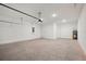 Large garage with white walls, concrete floors, and water heater at 5719 Cattle Ranch Dr, St Cloud, FL 34771